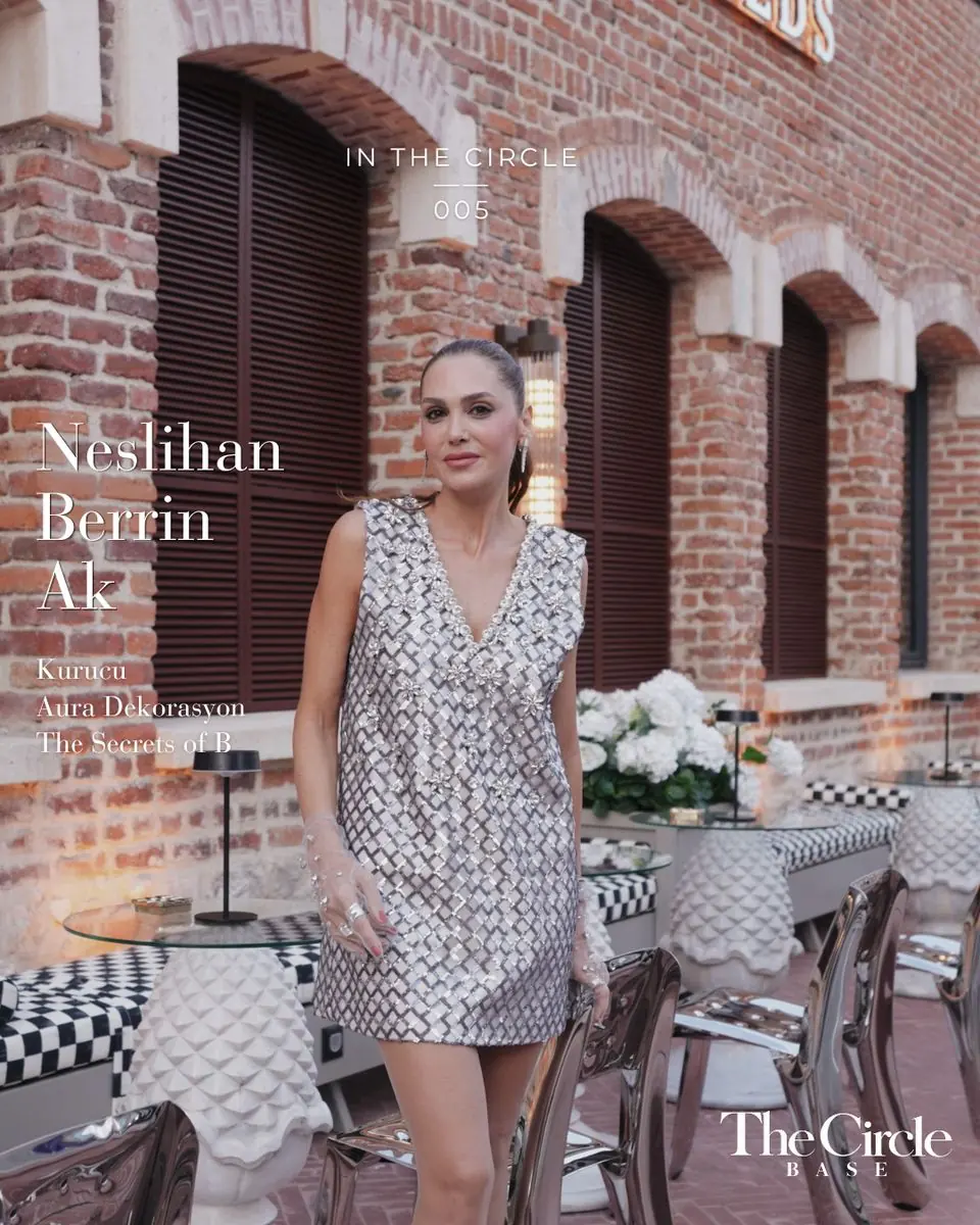 Neslihan Berrin Ak in a beaded silver dress on a brick terrace