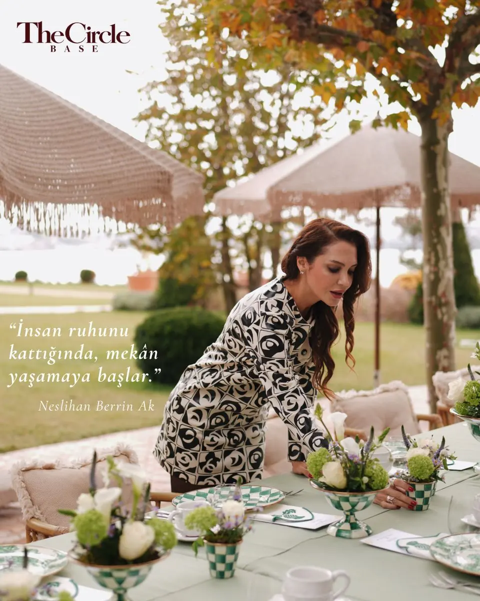 Neslihan Berrin Ak arranging flowers on a long garden table, with a quote