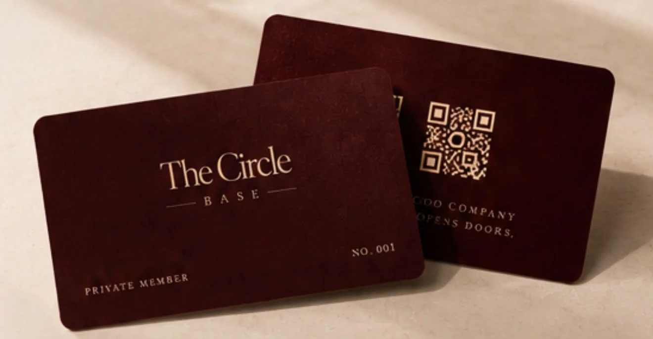 Two burgundy Circle Cards embossed in gold: The Circle Base, private member
