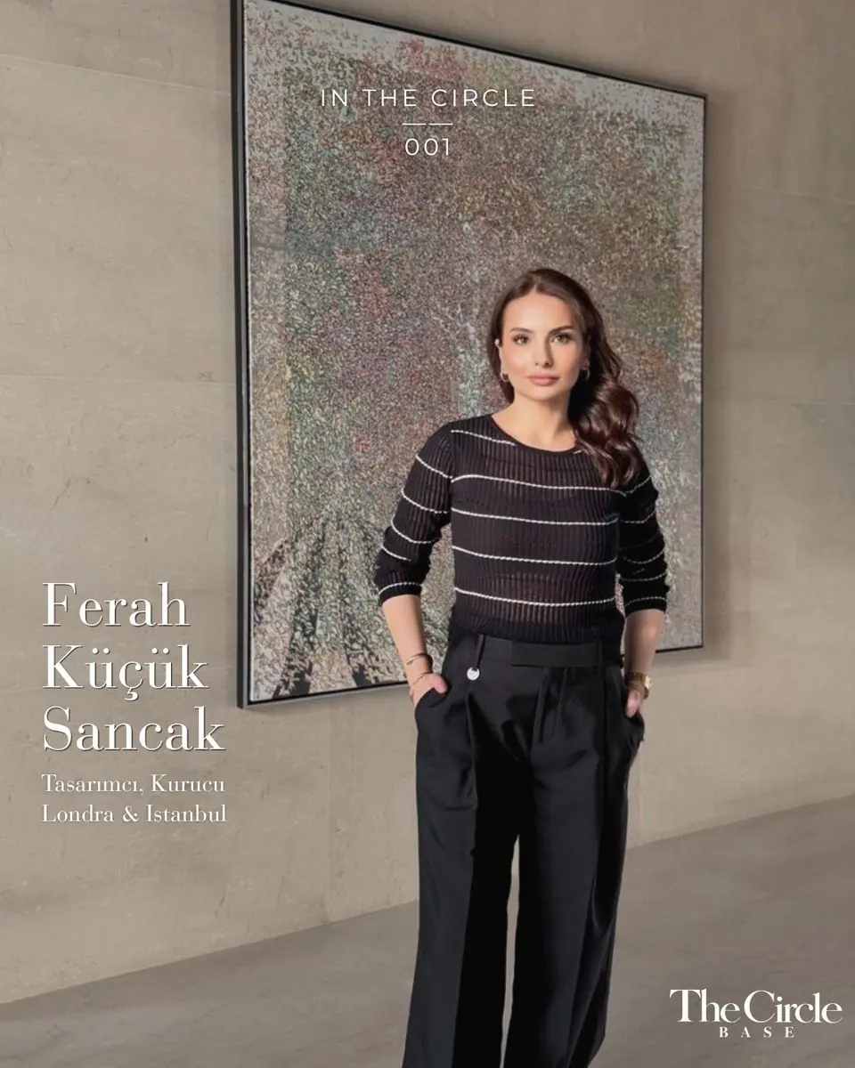 Ferah Küçük Sancak standing in front of a large abstract painting