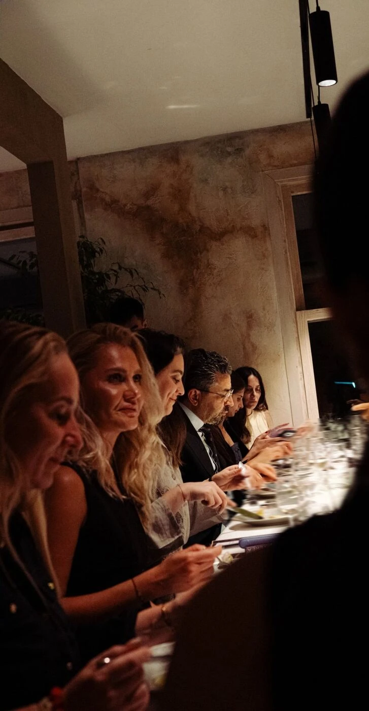 The circle, seated together along the table