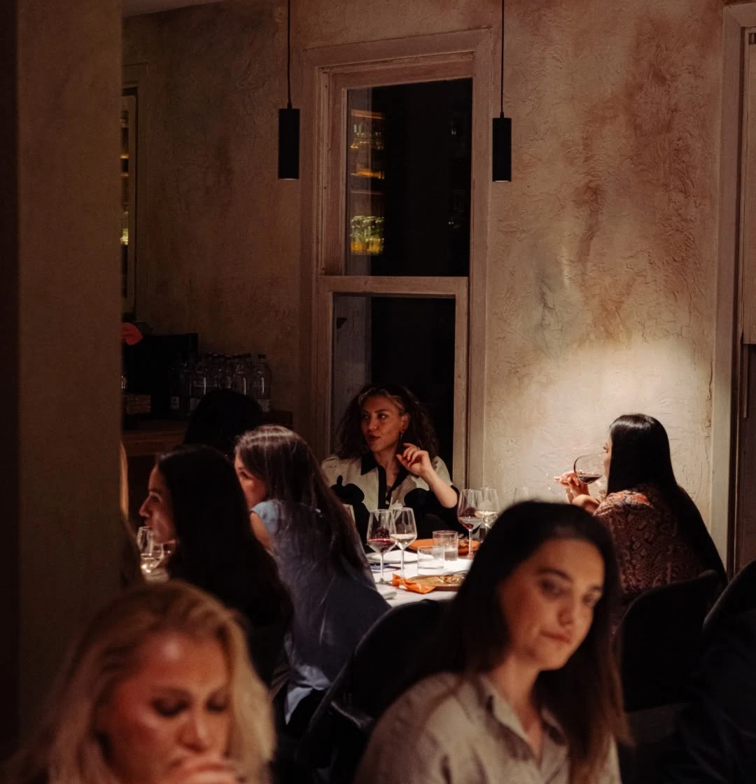 Women dining in a warm, low-lit room